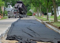 forms, fabric, and crushed stone are placed below the pavement